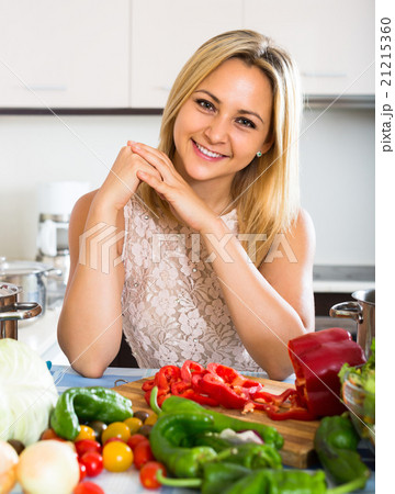 Girl cooking with veggies at home. Girl cooking with veggies at home. 21215360
