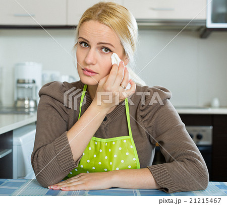 Sad woman sitting at kitchen 21215467
