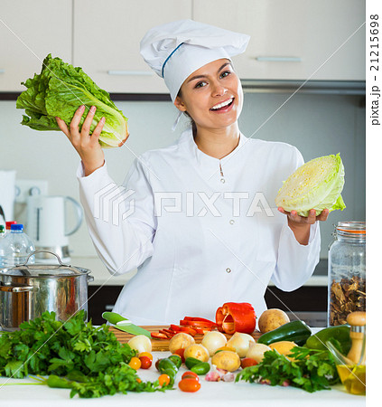 Portrait of professional chef with vegetables Portrait of professional chef with vegetables 21215698