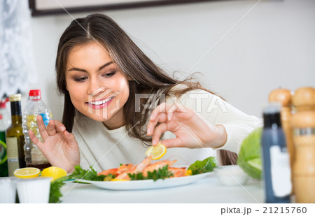 Woman decorating fried prawns 21215760