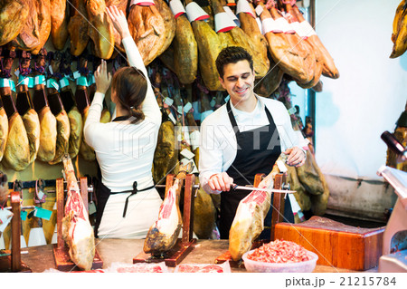 Portrait of sellers offering tasty jamon 21215784