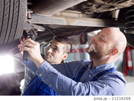 Smiling men in coveralls working 21216208
