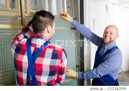 Two smiling workmen at factory Two smiling workmen at factory 21216209