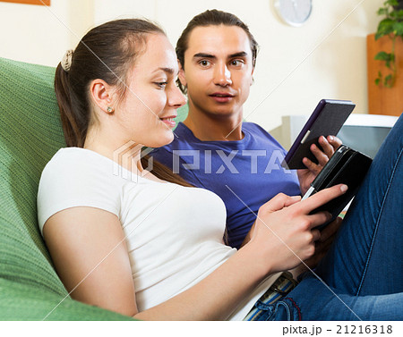 Couple reading from eBook screen Couple reading from eBook screen 21216318