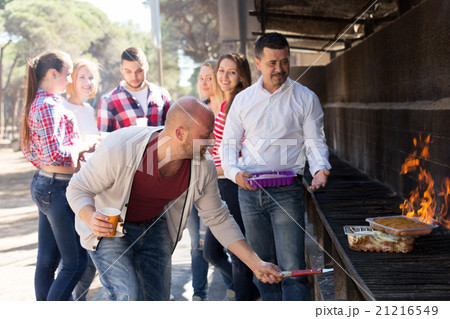 friends relaxing at grill party friends relaxing at grill party 21216549