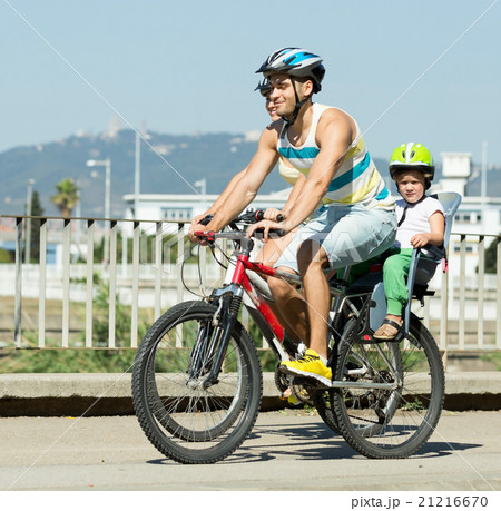 Family of four cycling on street Family of four cycling on street 21216670