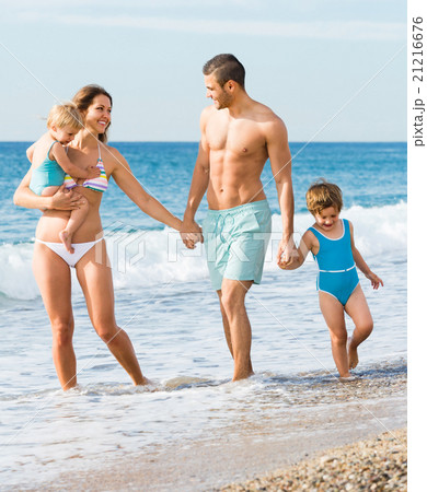 Family of four at the beach Family of four at the beach 21216676