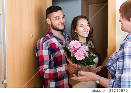 Couple came to mother with flowers Couple came to mother with flowers 21216679