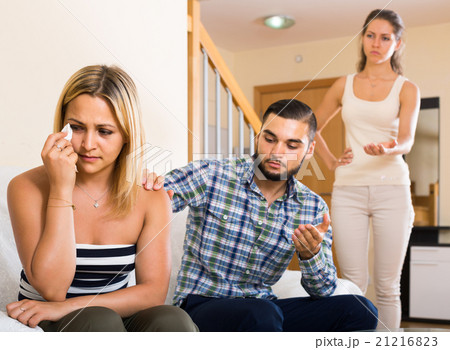 person keeping silence turned away from friends person keeping silence turned away from friends 21216823