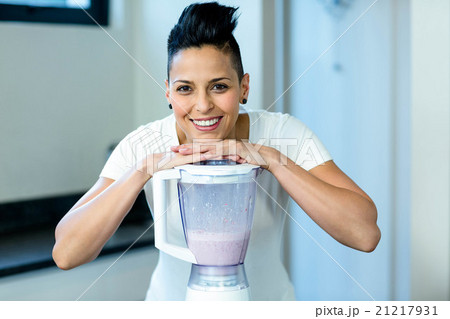 Pregnant woman leaning on blender Pregnant woman leaning on blender 21217931