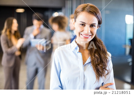 Confident businesswoman looking at camera in office Confident businesswoman looking at camera in office 21218051