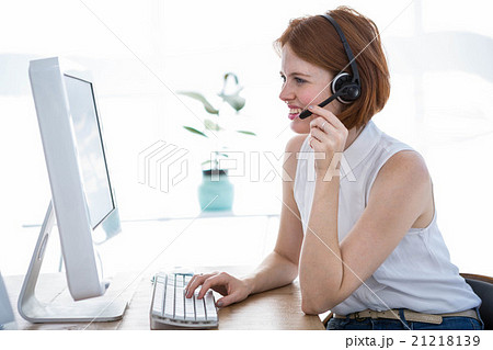 smiling hipster business woman wearing a headset smiling hipster business woman wearing a headset 21218139