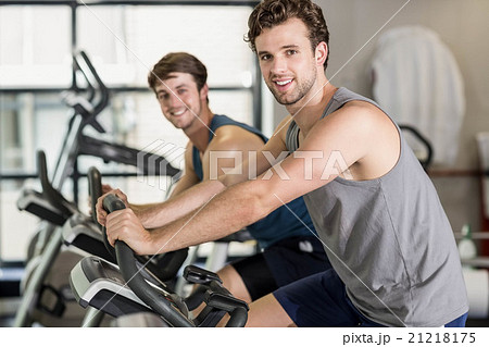 Fit people doing exercise bike 21218175
