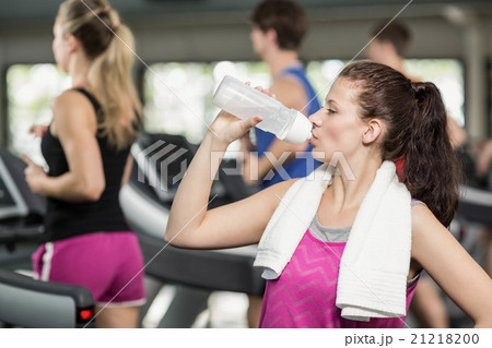 Fit woman posing while drinking Fit woman posing while drinking 21218200