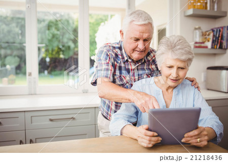 Senior couple using digital tablet Senior couple using digital tablet 21218436