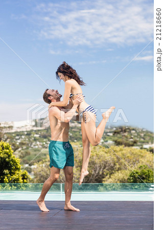 Young couple enjoying near pool Young couple enjoying near pool 21218660