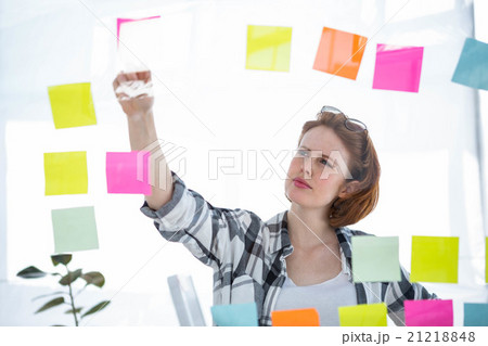 thoughtful hipster woman brainstorming over notes thoughtful hipster woman brainstorming over notes 21218848