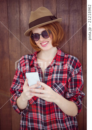 smiling hipster woman on her smartphone smiling hipster woman on her smartphone 21218962