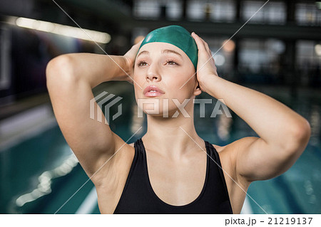 Pretty woman adjusting her bathing cap 21219137