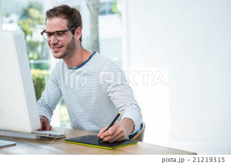 Handsome man working on computer Handsome man working on computer 21219315