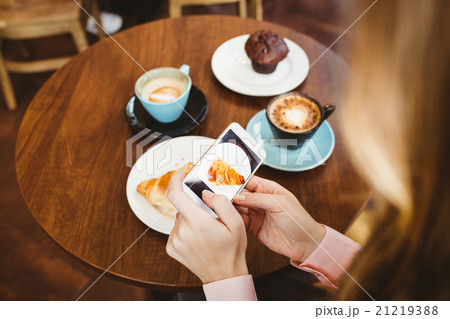 Woman taking picture of food Woman taking picture of food 21219388