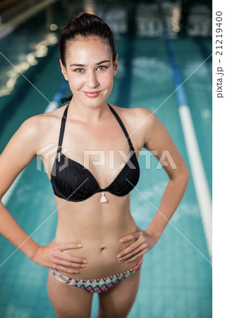 Fit woman in swimsuit with hands on hips 21219400