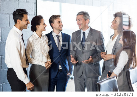 Businesspeople interacting in conference room 21220271
