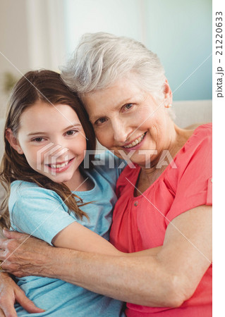 Portrait of grandmother and granddaughter embracing Portrait of grandmother and granddaughter embracing 21220633