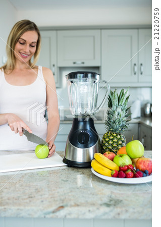 Pretty blonde woman preparing a smoothie Pretty blonde woman preparing a smoothie 21220759
