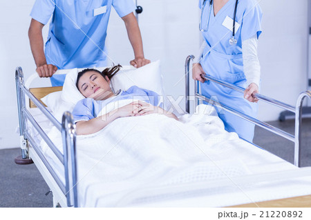 Doctors standing near patient bed 21220892