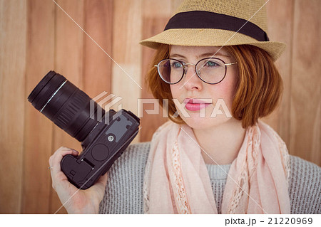 Hipster smiling and holding camera Hipster smiling and holding camera 21220969