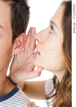 Young couple sharing a secret Young couple sharing a secret 21220982