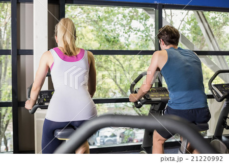 Fit people doing exercise bike Fit people doing exercise bike 21220992