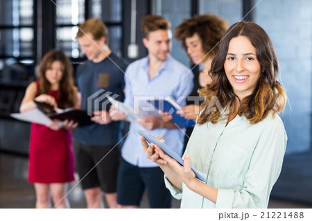 Portrait of smiling woman holding a digital tablet 21221488
