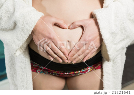 Pregnant woman making heart shape with hands 21221641