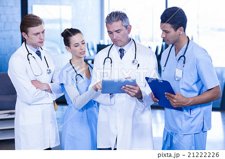 Doctors looking in digital tablet Doctors looking in digital tablet 21222226