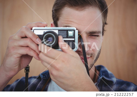 Handsome hipster taking picture with retro camera Handsome hipster taking picture with retro camera 21222257