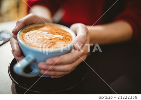 Woman holding a cup of coffee Woman holding a cup of coffee 21222359