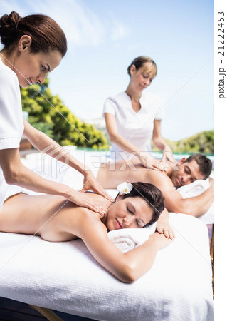 Young couple receiving a back massage from masseur Young couple receiving a back massage from masseur 21222453