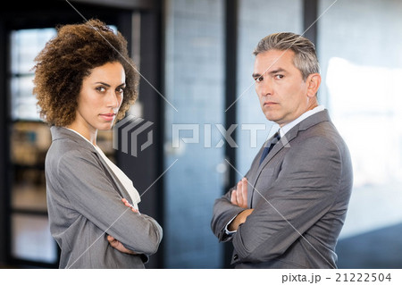 Businessman and businesswoman with arms crossed Businessman and businesswoman with arms crossed 21222504