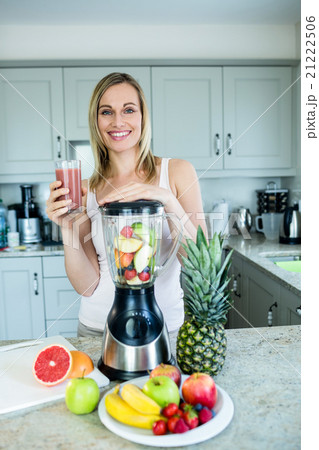 Pretty blonde woman holding her homemade smoothie 21222506