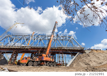 Crane working near bridge 21232991