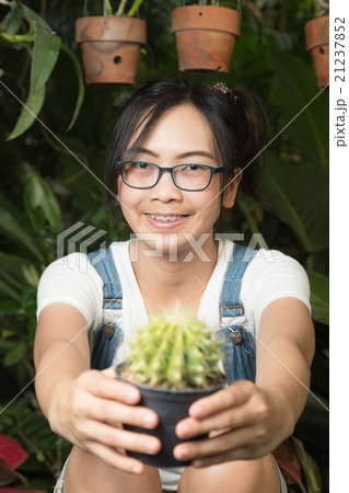 Woman holding a cactus Woman holding a cactus 21237852