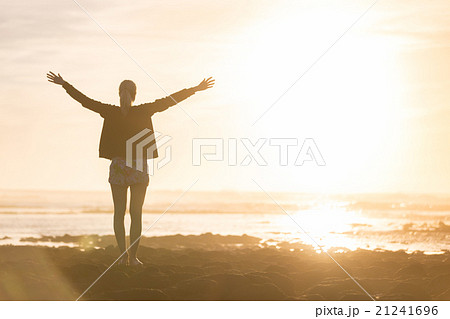 Free woman enjoying freedom on beach at sunset. 21241696