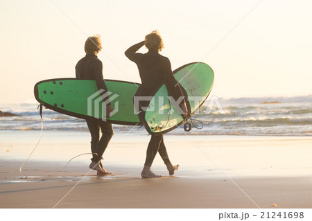Surfers on beach with surfboard. 21241698