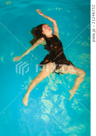 Woman floating relaxing in swimming pool water. Woman floating relaxing in swimming pool water. 21246752