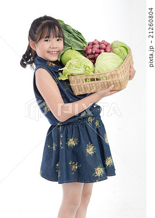Asian girl with vegetables in baske Asian girl with vegetables in baske 21260804