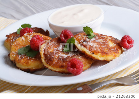 Cheese pancakes with raspberries and sour cream Cheese pancakes with raspberries and sour cream 21263300