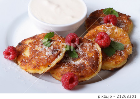 Cheese pancakes with raspberries and sour cream 21263301