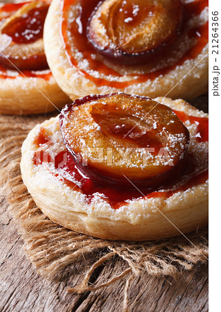 Cakes of flaky pastry with plums close up vertical Cakes of flaky pastry with plums close up vertical 21264366